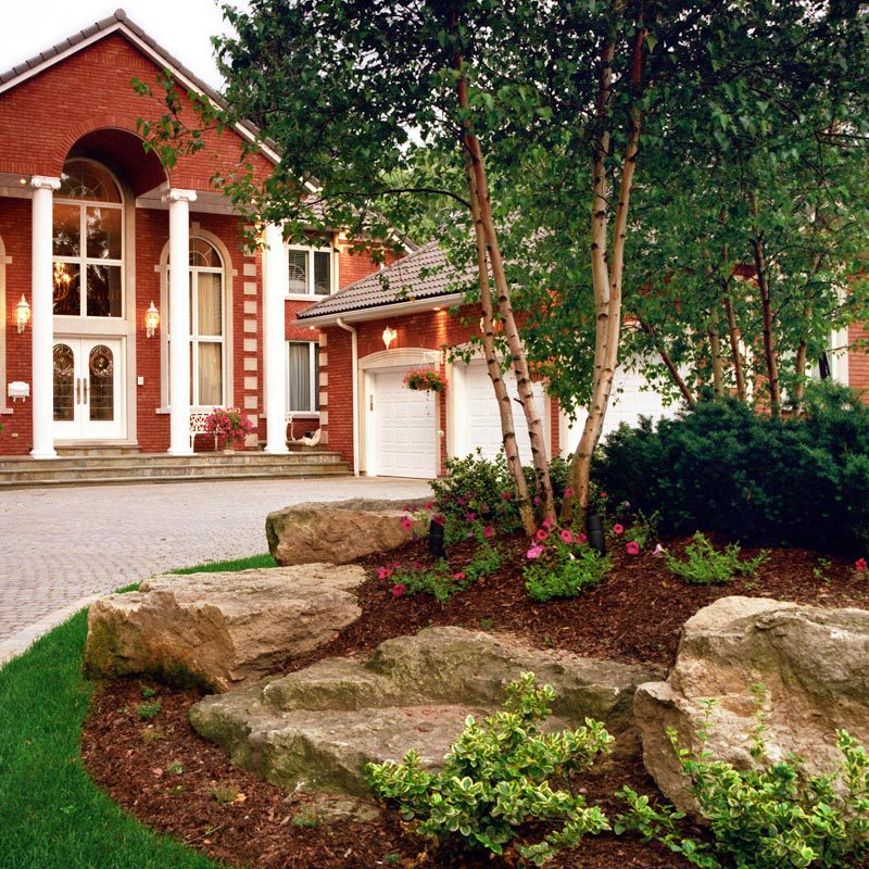 chitwood-dirt-yard-landscaping Chitwood Dirt Yard | Rock Hill, SC | nice brick home with stone driveway and yard landscaped with stones, pink flowers, and mulch